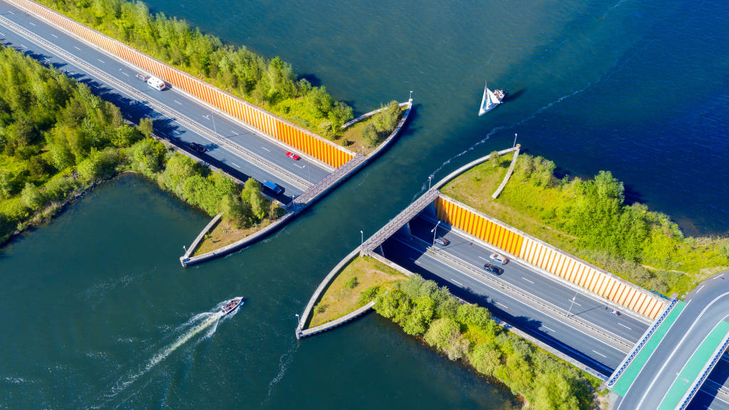 Aquaduct Veluwemeer, Nederland. Aerial view from the drone. A sailboat sails through the aqueduct on the lake above the highway